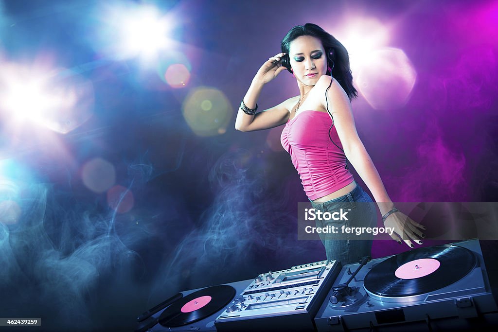 Beautiful DJ girl at the club Beautiful DJ girl with bright lights Adult Stock Photo