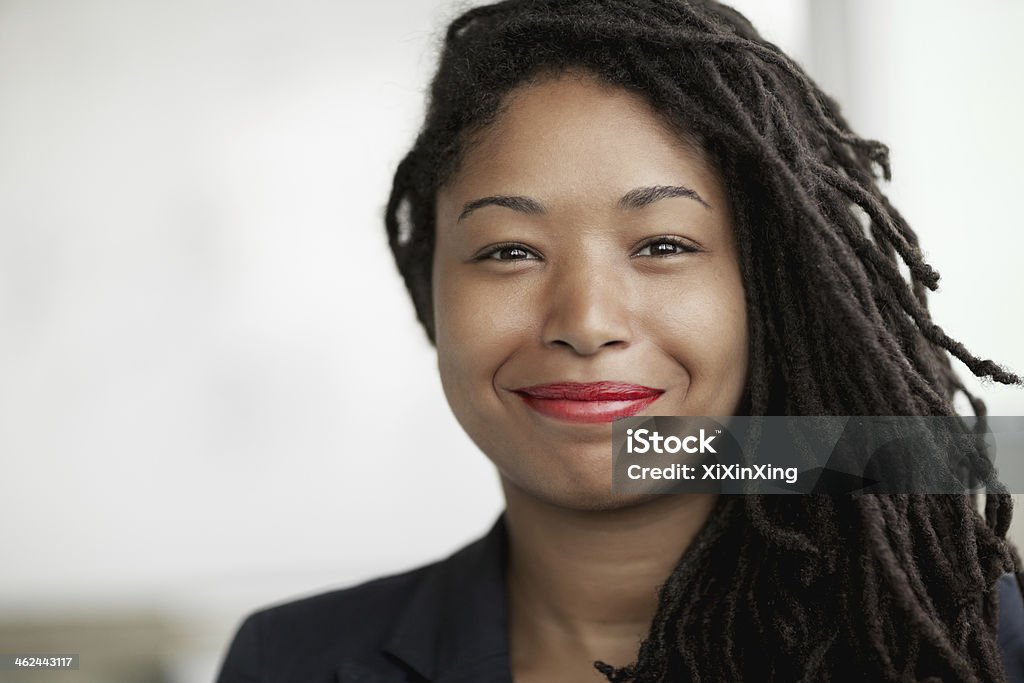Portrait of smiling businesswoman with dreadlocks, head and shoulders African Ethnicity Stock Photo