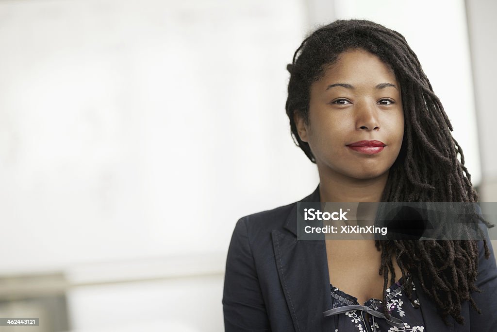 Portrait of smiling businesswoman with dreadlocks, head and shoulders Business Stock Photo