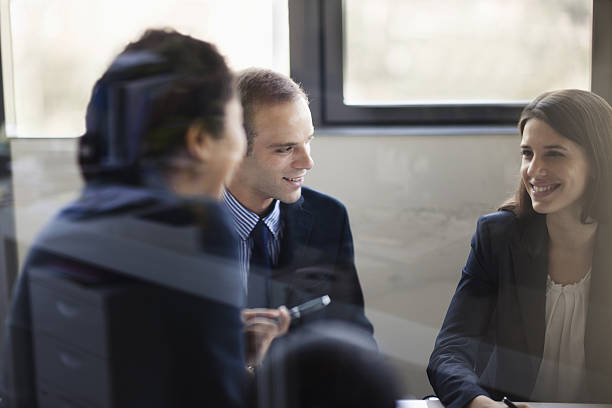 istock Three people smiling in business meeting 462443133