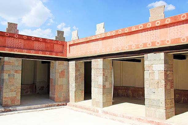The ruins near Oaxaca feature the distinct patterned stonework of the Zapotec civilization, with intricately carved decorative tiles covering the ancient walls