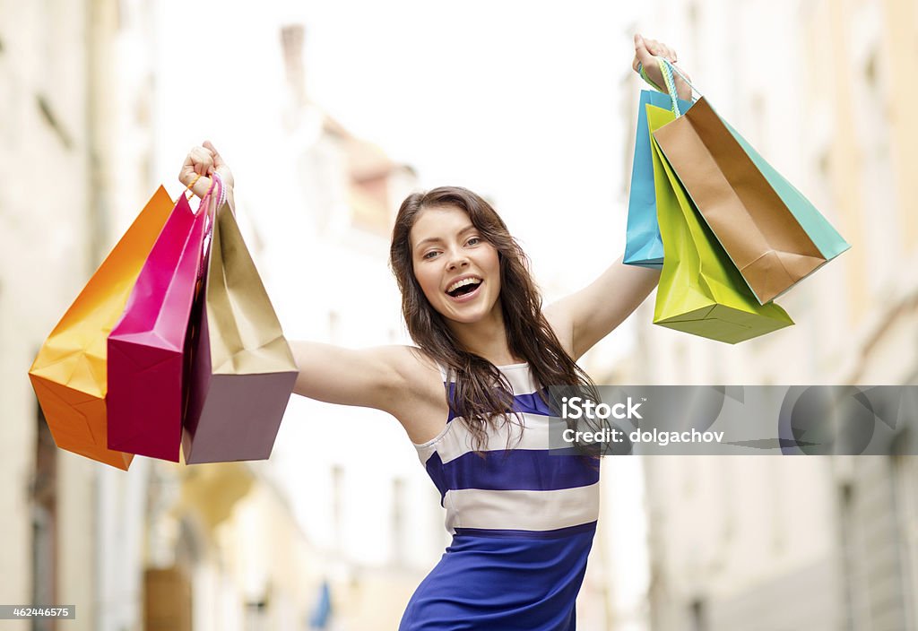 beautiful woman with shopping bags in ctiy sale, shopping, tourism and happy people concept - beautiful woman with shopping bags in ctiy Animal Stock Photo