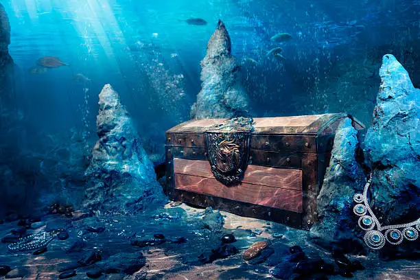 wooden treasure chest submerged underwater with light rays