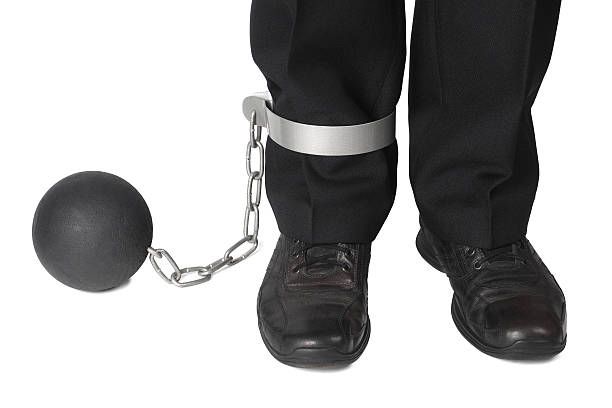 istock Businesman with ball and chain 462451121