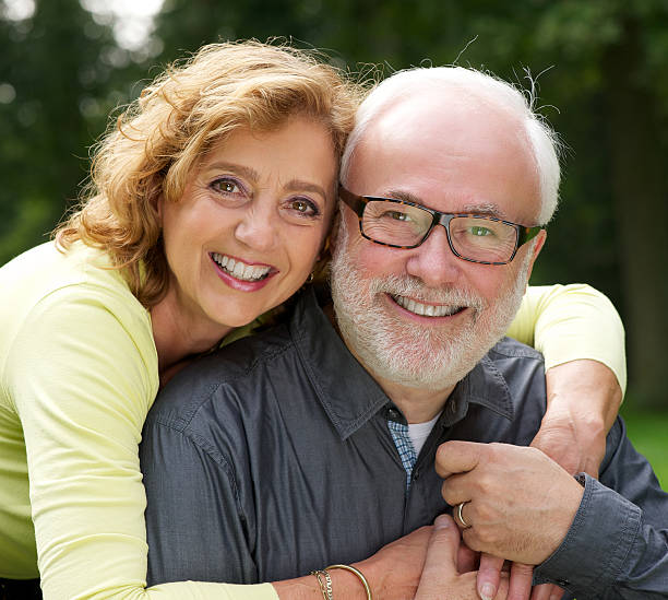 istock Husband and wife smiling outside 462452767
