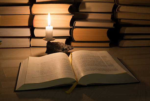 istock Gospel New Testament, candle and other books 462454013