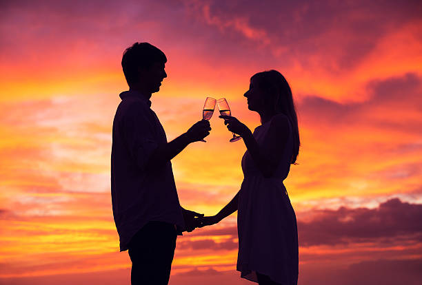 istock Silhouette of couple drinking champagne at sunset 462455691