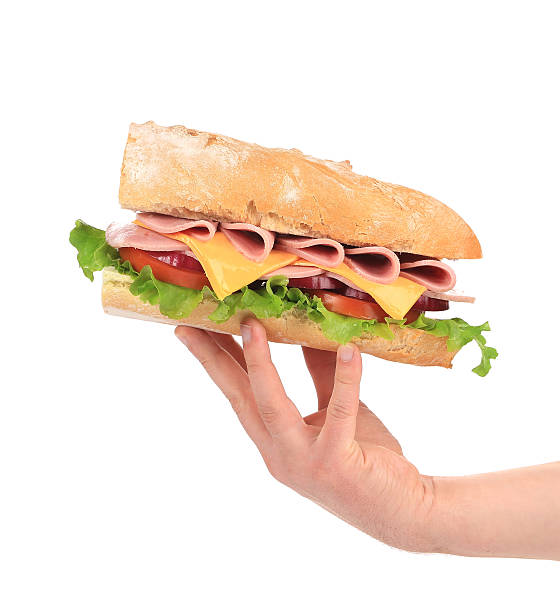 istock French baguette fresh sandwich in hand. 462455827