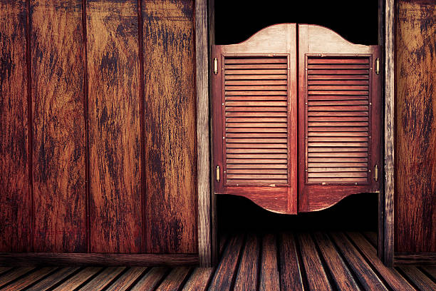 Old vintage wooden saloon doors Old western swinging Saloon doors saloon doors stock pictures, royalty-free photos & images