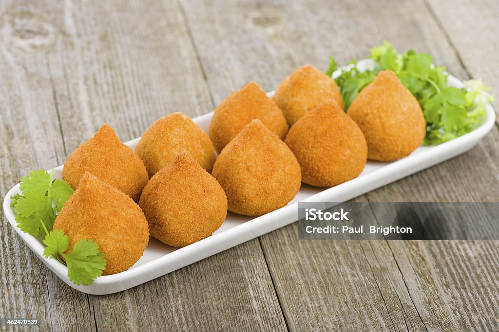 Chicken Coxinha Coxinha de Galinha - Brazilian deep fried chicken snack, popular at local parties. Served with chili sauce. Savory Food Stock Photo