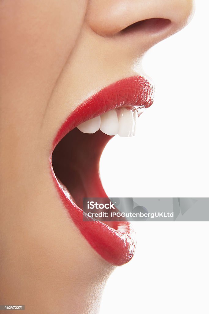 Surprised Young Woman With Red Lips Side view of surprised young woman with red lips on white background Mouth Open Stock Photo