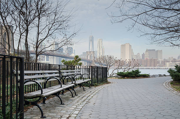 istock Brooklyn Bridge Park Bench and Walkway with Manhattan Skyline. 462473189