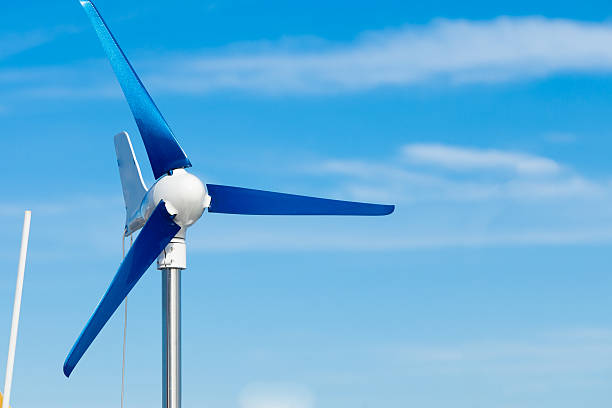 istock Wind turbine producing alternative energy renewable power on blue sky 462479105