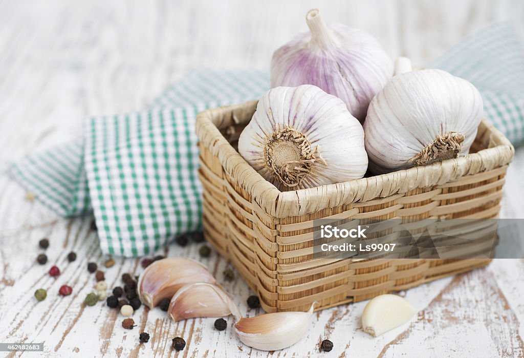 Garlic Garlic with peppercorns on a wooden background Agriculture Stock Photo