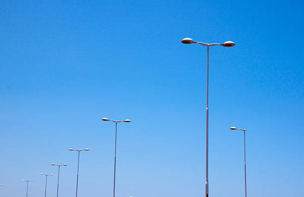 istock Multiple Street Lamps Against Bright Blue Skyline 462486959