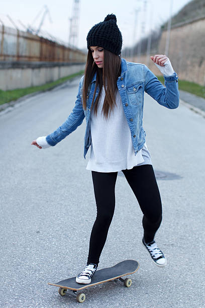 istock Young woman on the road with a skateboard 462488733