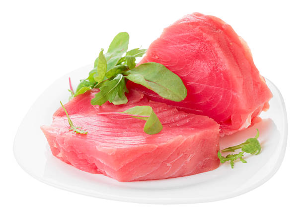 istock Tuna steaks with salad isolated on white 462493197