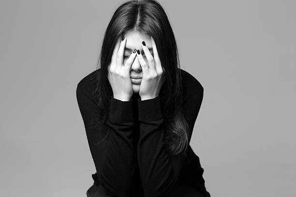 istock woman with hands over her head 462493753