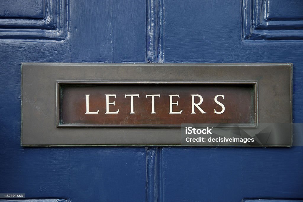 Traditional letter box Close up of a traditional letter box on a blue front door. Architectural Feature Stock Photo