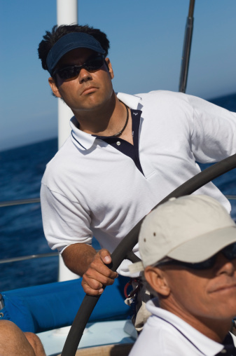 Man at the Helm of Sailboat During Race