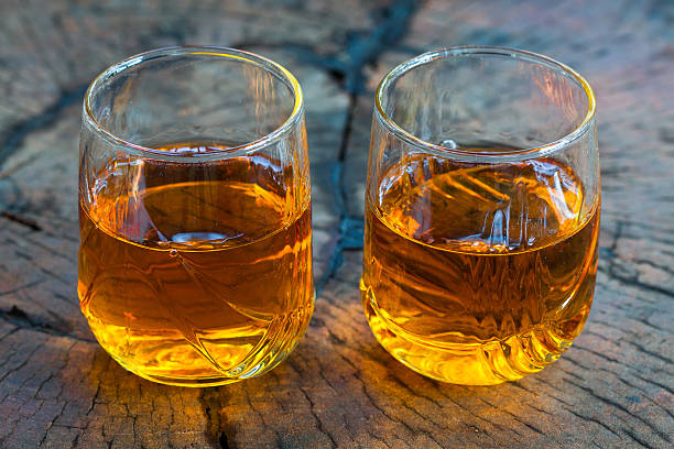 Golden Brown Whisky on the rocks in a glass stock photo