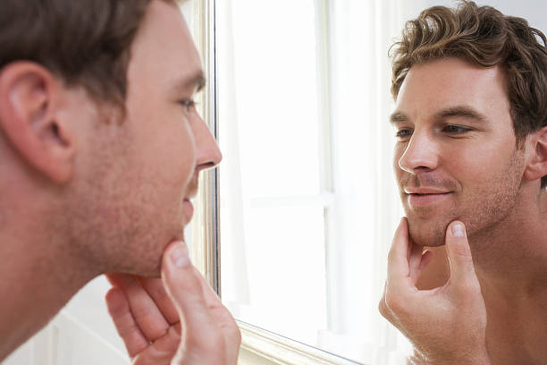 istock Man Examining His Stubble In Mirror 462501551