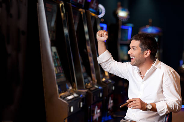 istock handsome man winning at the slot machine 462501601