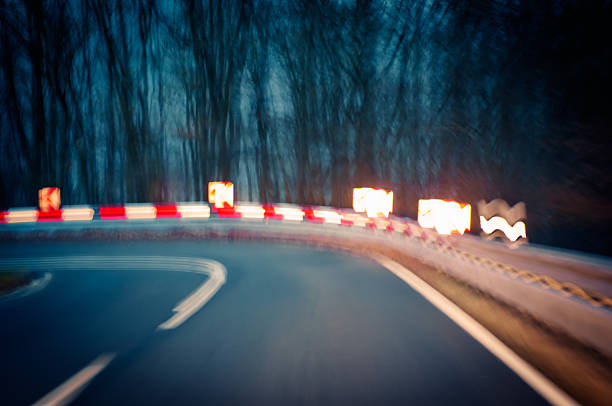 Person making a sharp turn at night stock photo