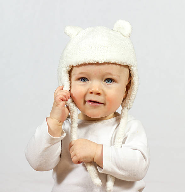 istock baby in white fur hat 462502501