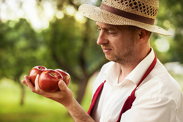 istock fruit grower in his orchard tasting apple harvest 462502657