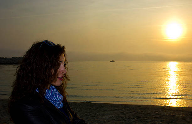 Beautiful young woman at sunset. Silhouette beautiful multi colored tranquil scene enjoyment stock pictures, royalty-free photos & images