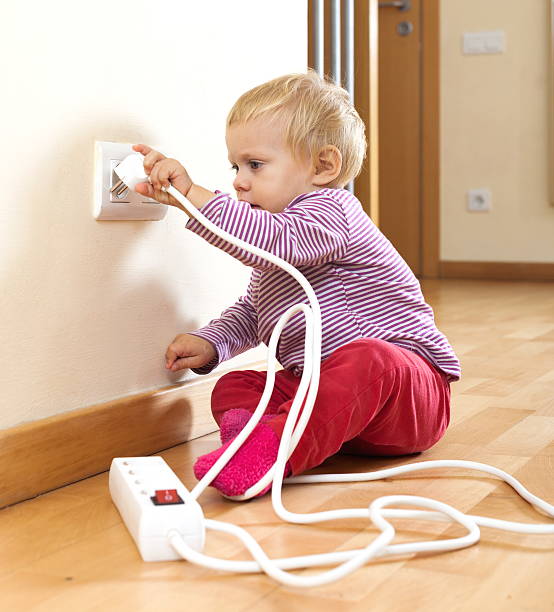 toddler playing with electricity at home Adorable toddler playing with electricity at home dimmer switch photos stock pictures, royalty-free photos & images