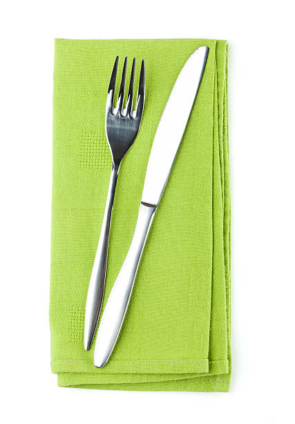 istock Silver knife and fork on folded green napkin 462513405