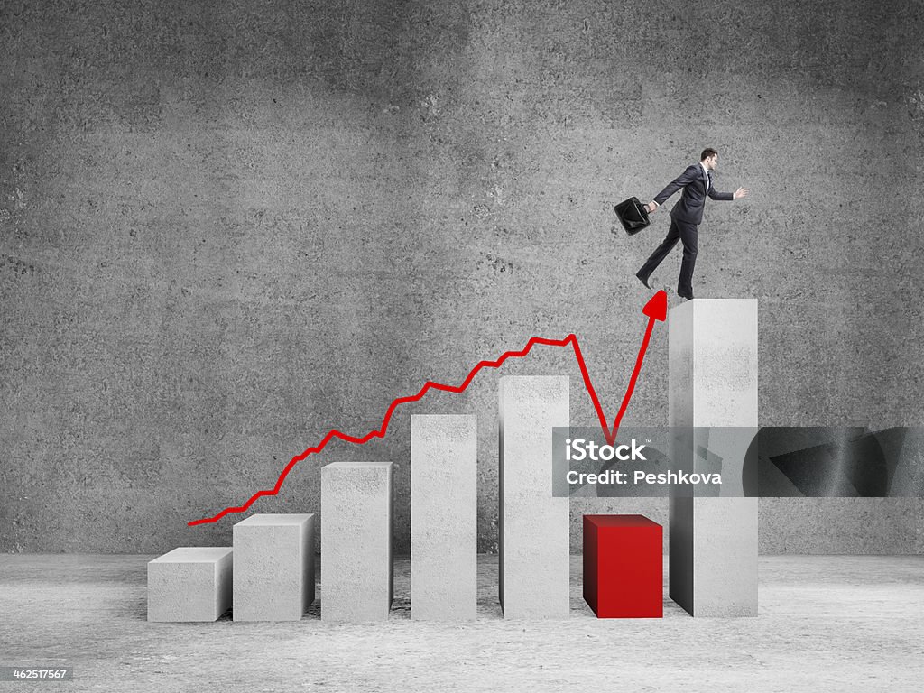 man jumping on graph businessman jumping on big graph  in room Adult Stock Photo