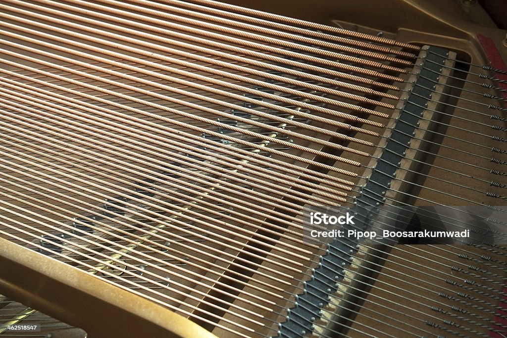 Closeup of grand piano showing strings, pegs and sound board. Detailed of grand piano inside, parallel strings Abstract Stock Photo