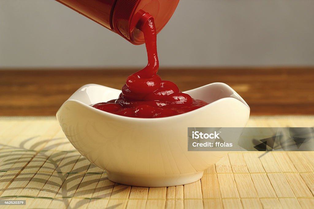 Pouring ketchup into bowl Bottle Stock Photo