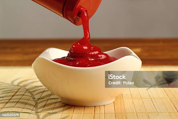 Pouring Ketchup Into Bowl Stock Photo - Download Image Now - Bottle, Ketchup, Pouring