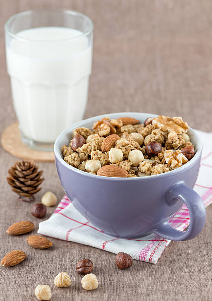 Cereal in a bowl and milk on the table