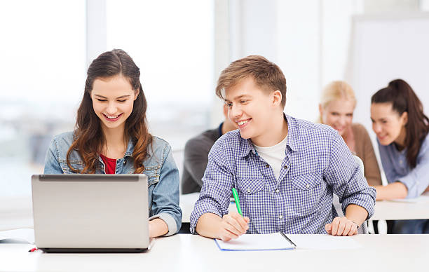 istock high school students with laptop and notebooks at school 462529769