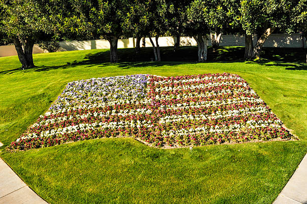 American flag made of colorful flowers An american flag made of flowers surrounded by grass american flag flowers stock pictures, royalty-free photos & images