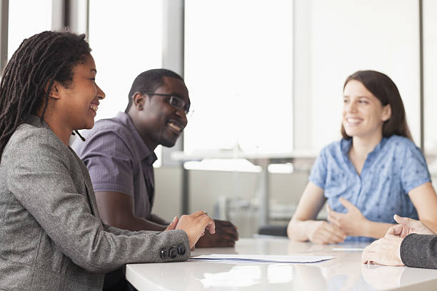istock Three business people sitting at a conference table 462535897