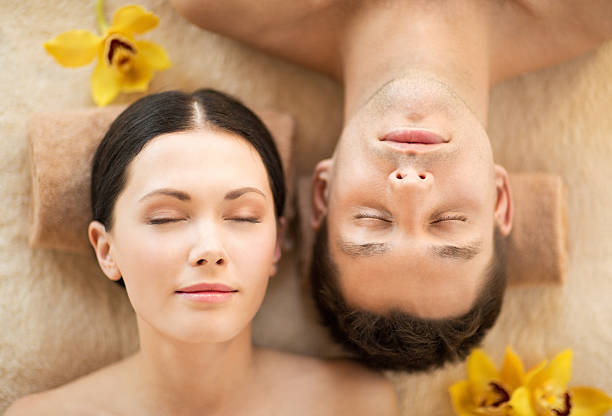 istock couple in spa salon lying on massage desk 462542231