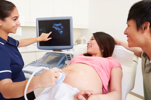 Mujer embarazada y pareja con ecografía 4D photo