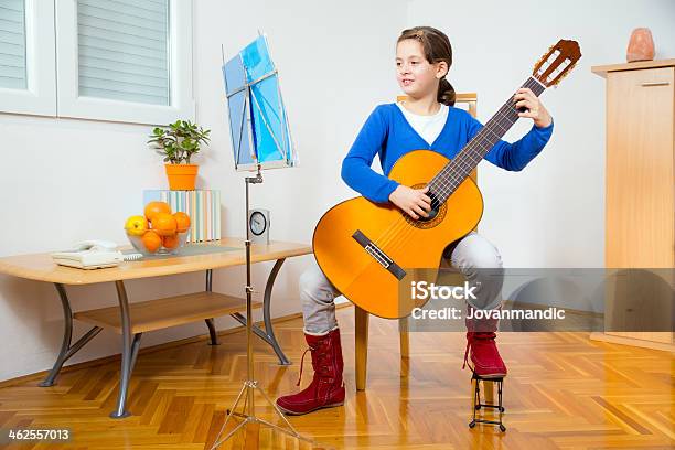 Young Girl Playing Guitar Stock Photo - Download Image Now - 8-9 Years, Acoustic Guitar, Arts Culture and Entertainment