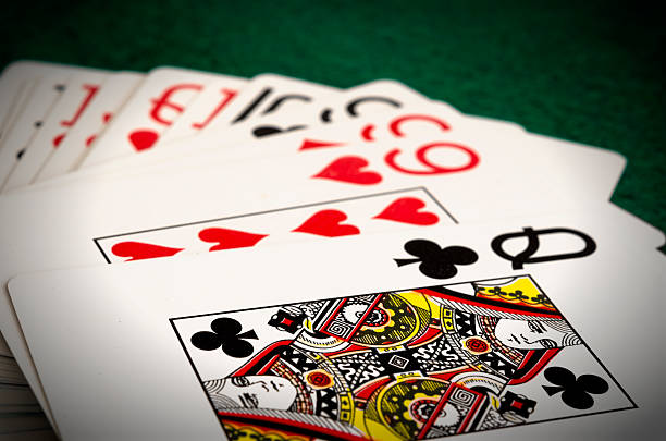 istock playing cards with casino chips on green table cloth 462561437