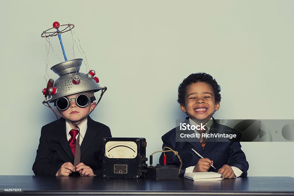 Business Boys Conduct Interview in Office Two young businessmen are trying to maximize their output for the business.  Child Stock Photo