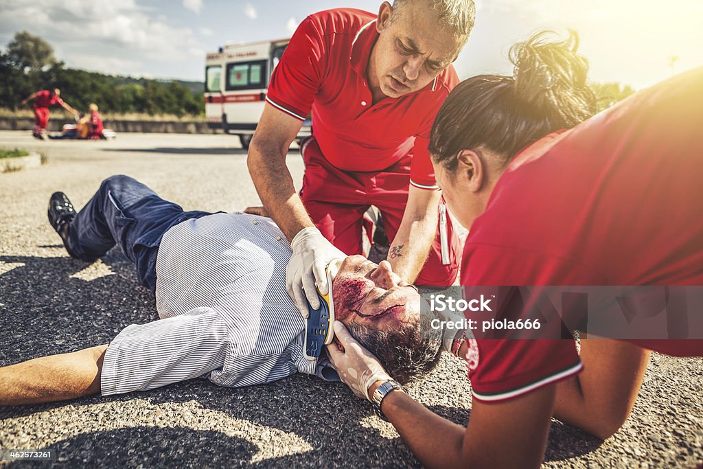 Medical emergency team arrives at street accident 60-69 Years Stock Photo