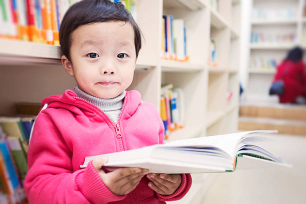 istock Cute asia children in the library 462576005