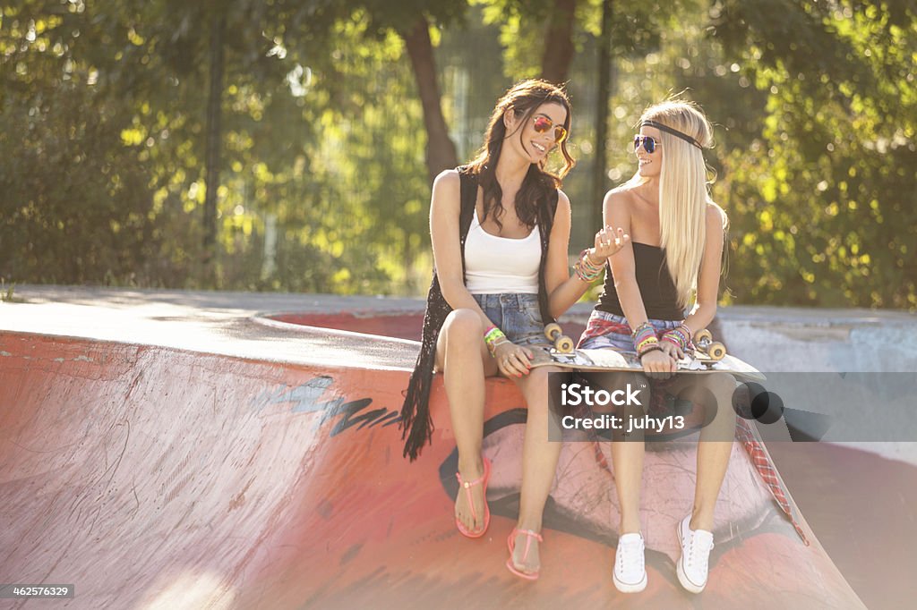 two young woman at skatepark Two young woman posing at the skatepark Adult Stock Photo