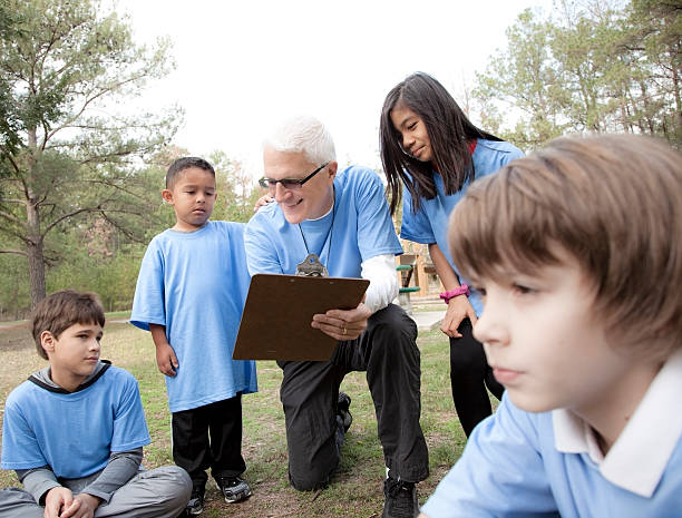 istock Sports: Senior volunteer coaches underprivileged children. 462576333